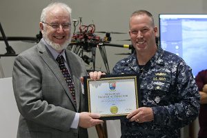 From left: Dr. Anthony Donaldson, California Baptist University School of Engineering dean and new Naval Surface Warfare Center (NSWC), Corona Division honorary technical director, left, and Capt. Stephen H. Murray, commanding officer of NSWC Corona, pose with certificate during a Naval Innovative Science and Engineering (NISE) project poster session. Principal investigators were on hand to showcase their projects, demonstrate how they can bring innovation to the the warfighter and strengthen NSWC Corona's technical capability. (U.S. Navy photo by Greg Vojtko/Released)